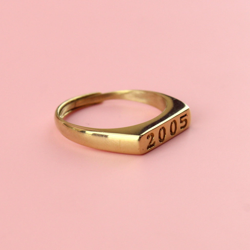 Gold plated stainless steel ring with 2005 engraved on the front