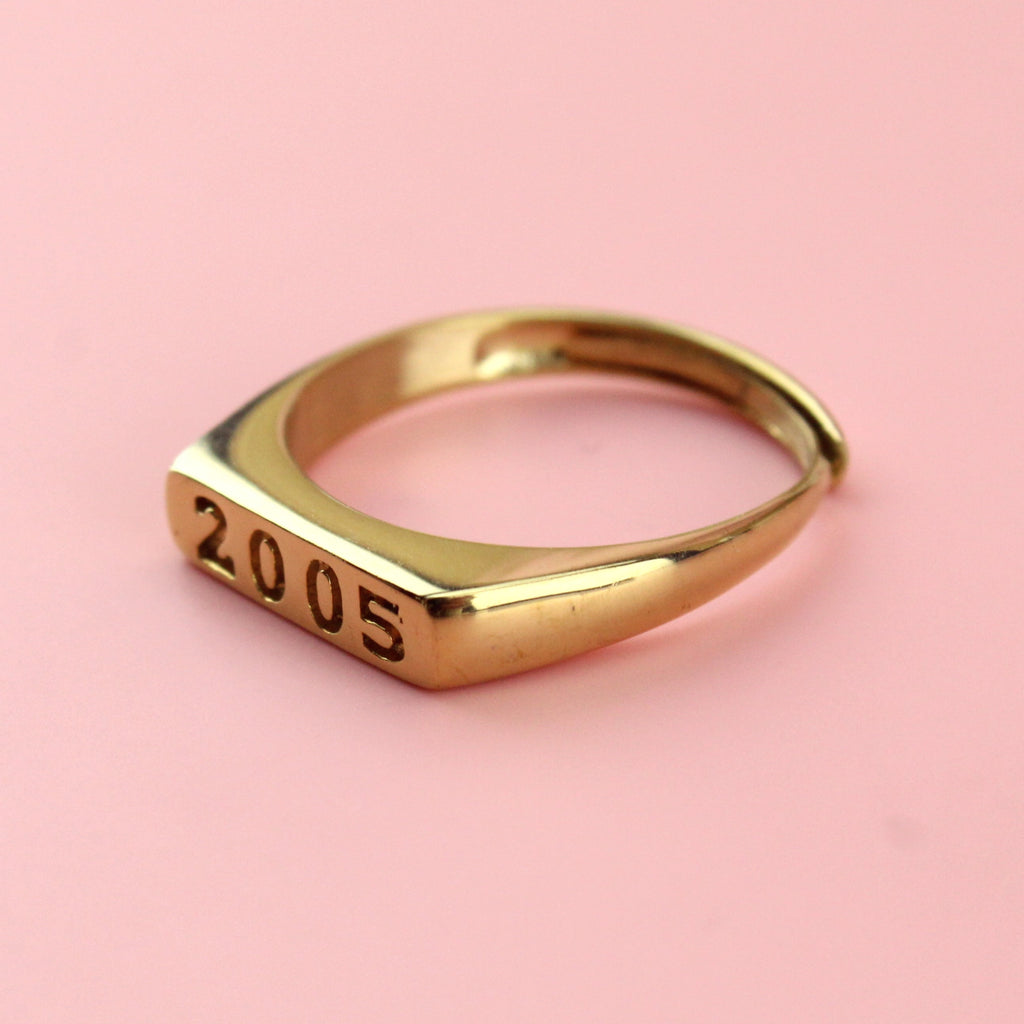 Gold plated stainless steel ring with 2005 engraved on the front