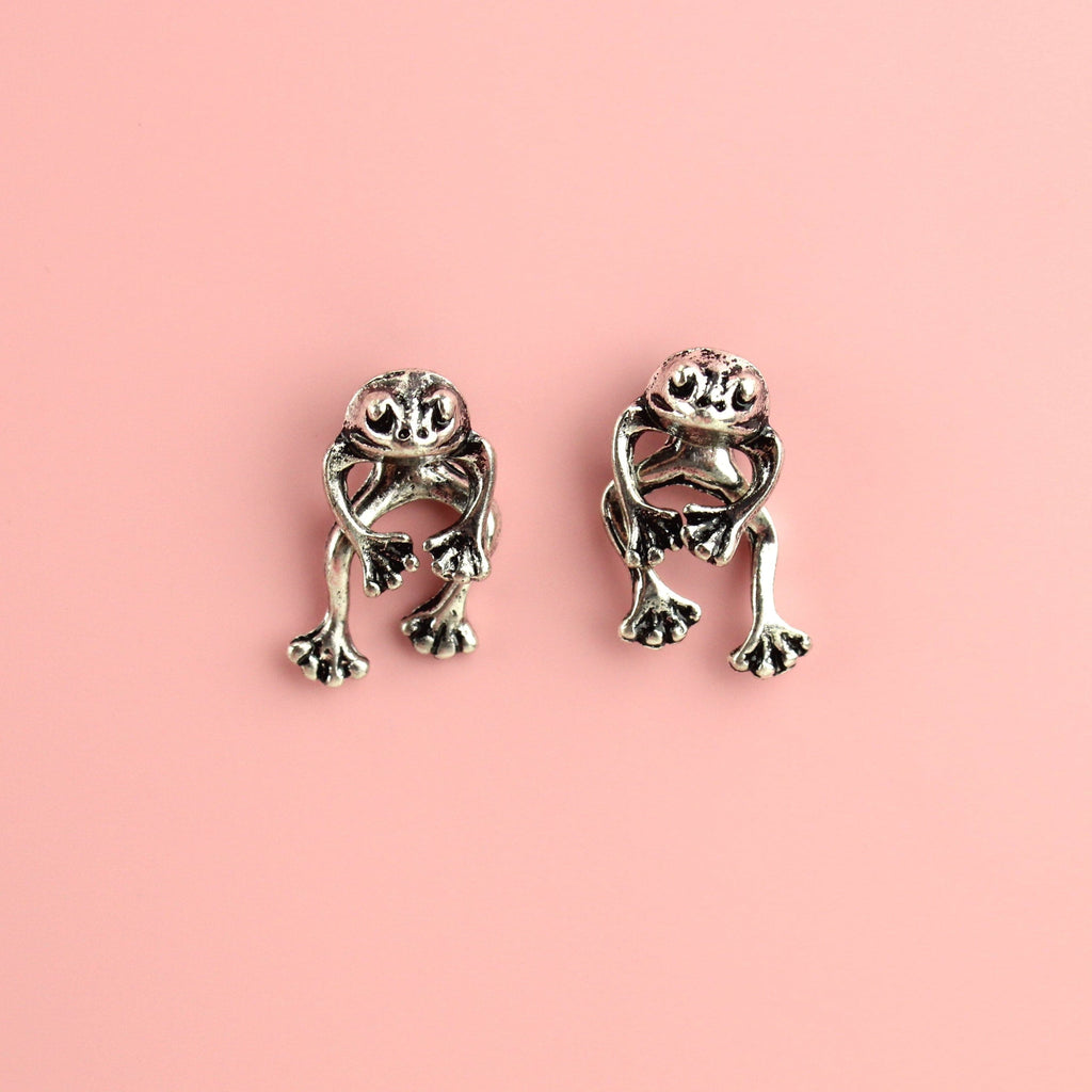 2 piece frog earrings - front piece includes the head and arms and the back piece includes the legs - made out of base metal