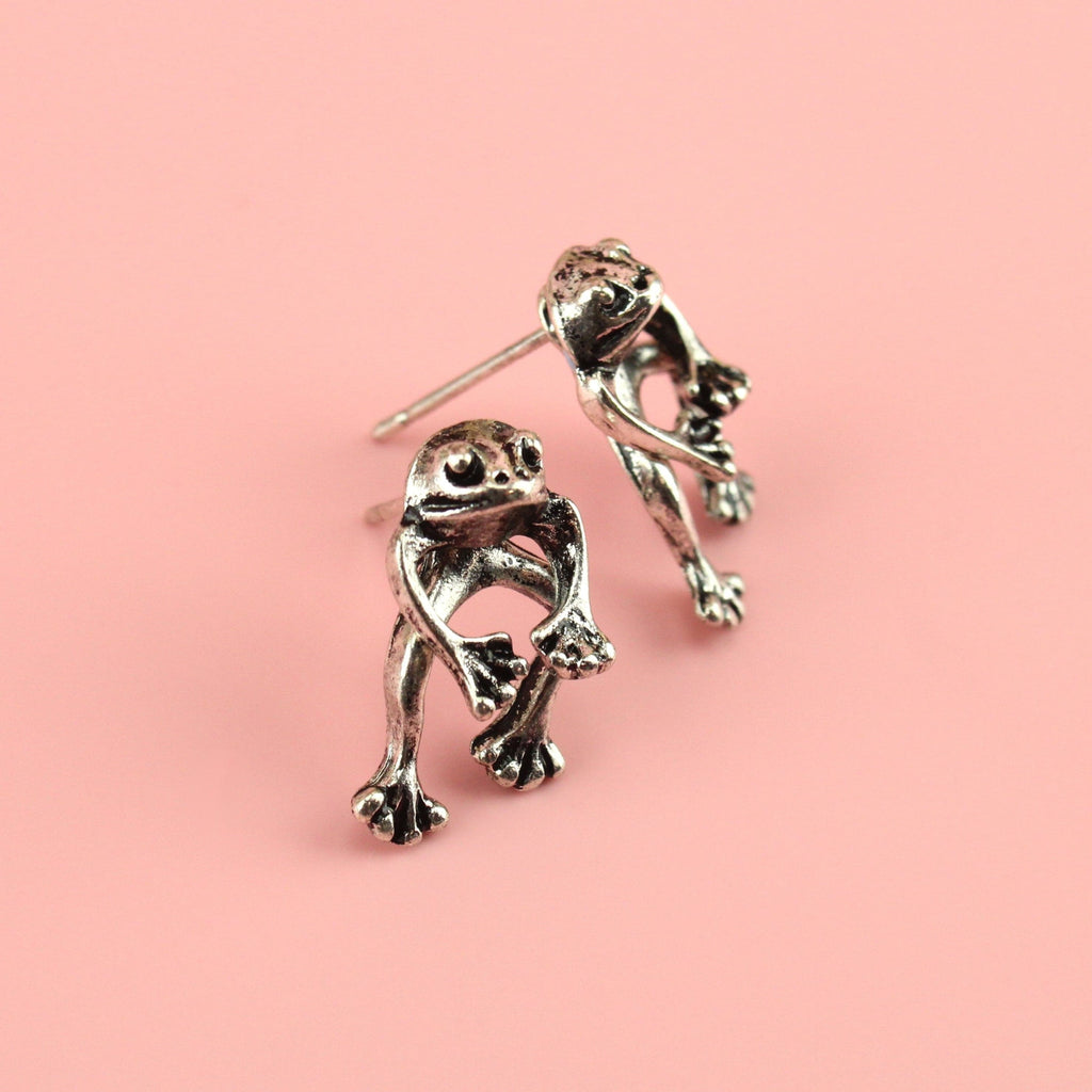 2 piece frog earrings - front piece includes the head and arms and the back piece includes the legs - made out of base metal