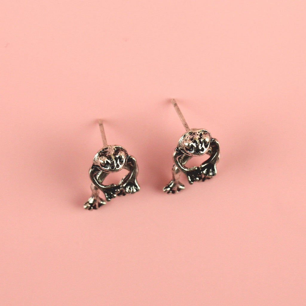 2 piece frog earrings - front piece includes the head and arms and the back piece includes the legs - made out of base metal