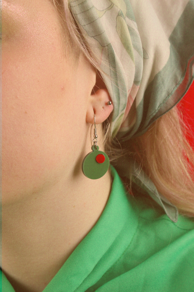 Model wearing Acrylic olive charms on stainless steel earwires