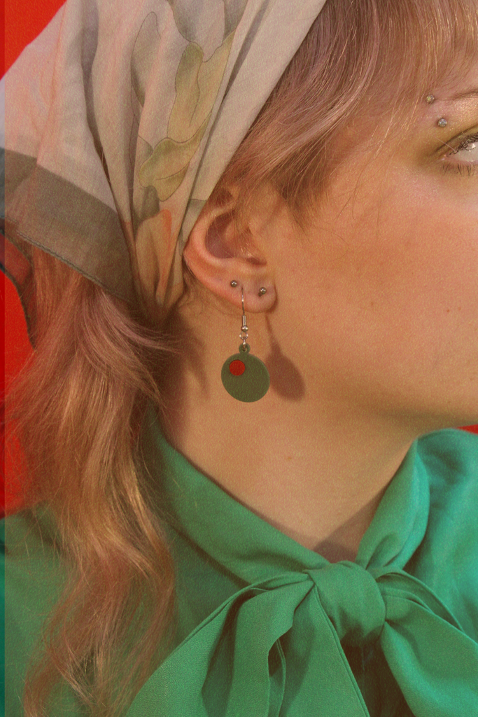 Model wearing Acrylic olive charms on stainless steel earwires