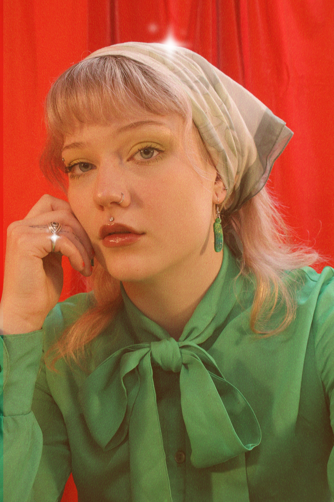 Model wearing Green acrylic dill pickle charms on stainless steel earwires