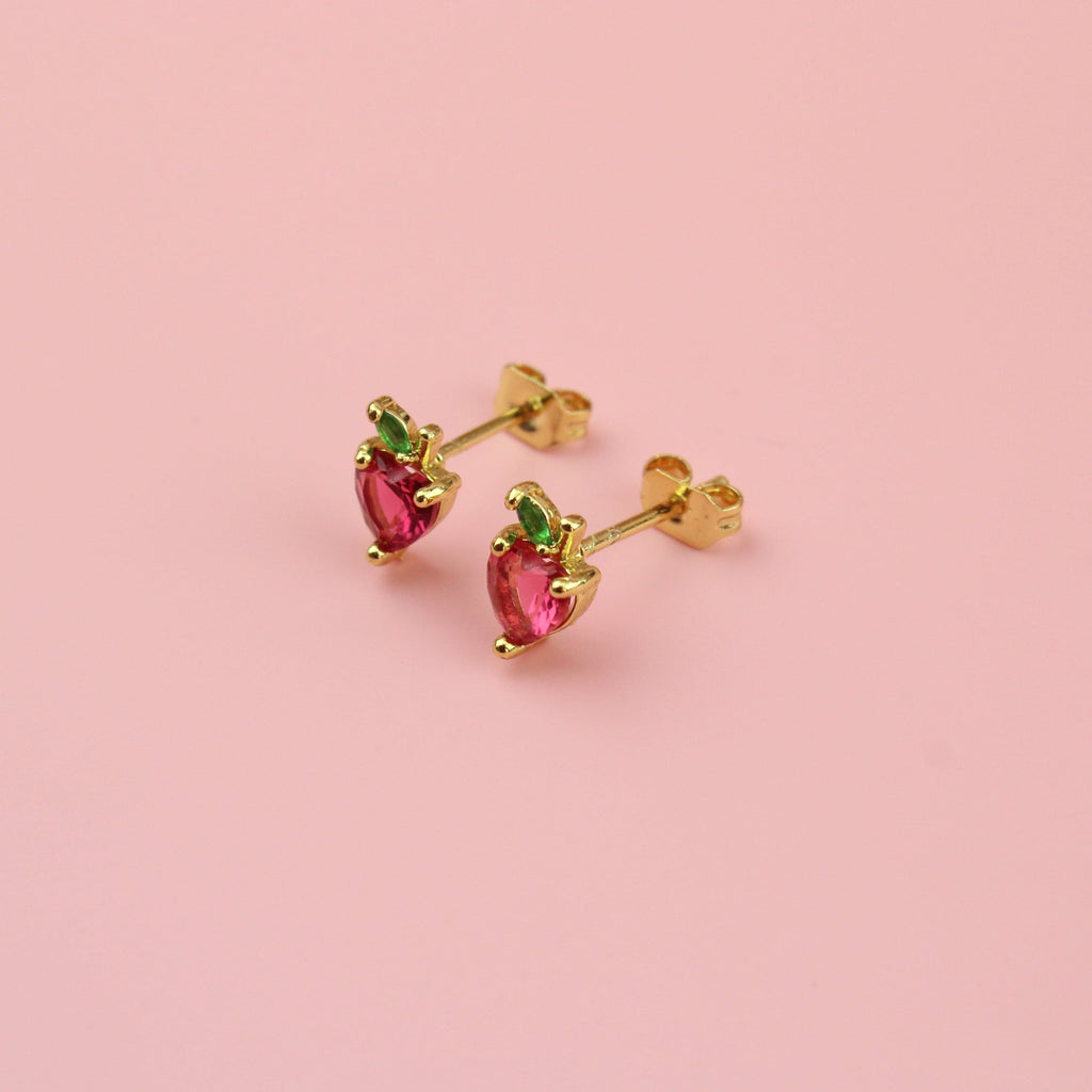 Apple shaped studs with red and green cubic zirconia and gold balls around the apple on gold plated base metal studs