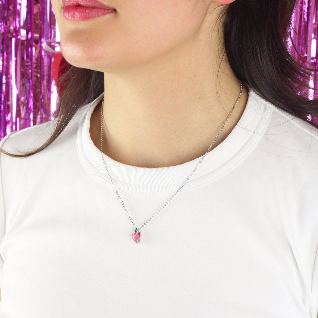 Model wearing Stainless steel chain with glass-effect pink apple pendant