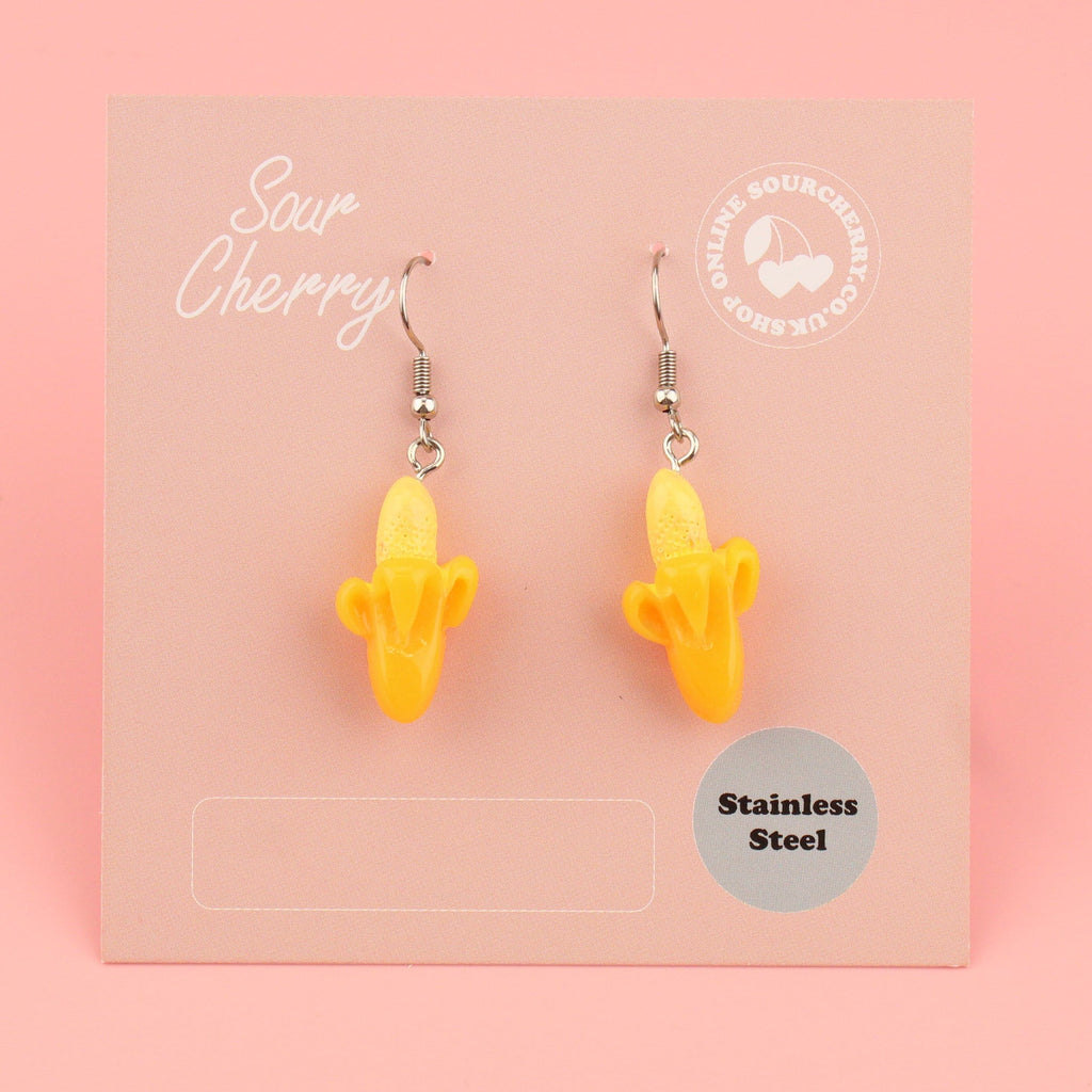 Half peeled resin banana charms on stainless steel earwires shown on the card