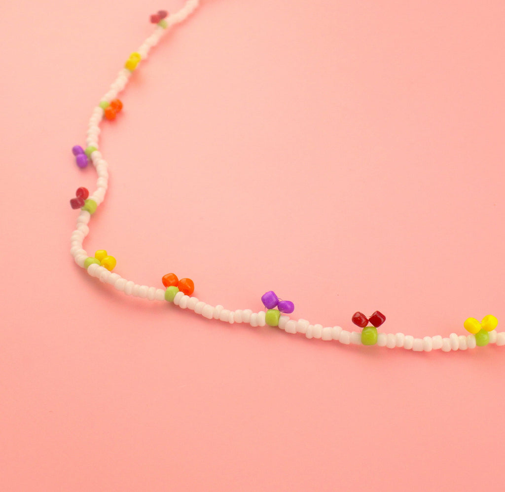Glass seed beaded necklace with yellow, orange, red and purple berry charms