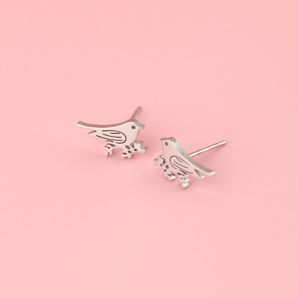 Stainless steel studs in the shape of a bird perched on a branch