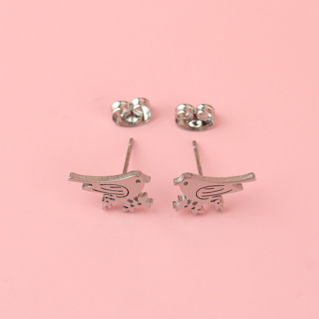 Stainless steel studs in the shape of a bird perched on a branch