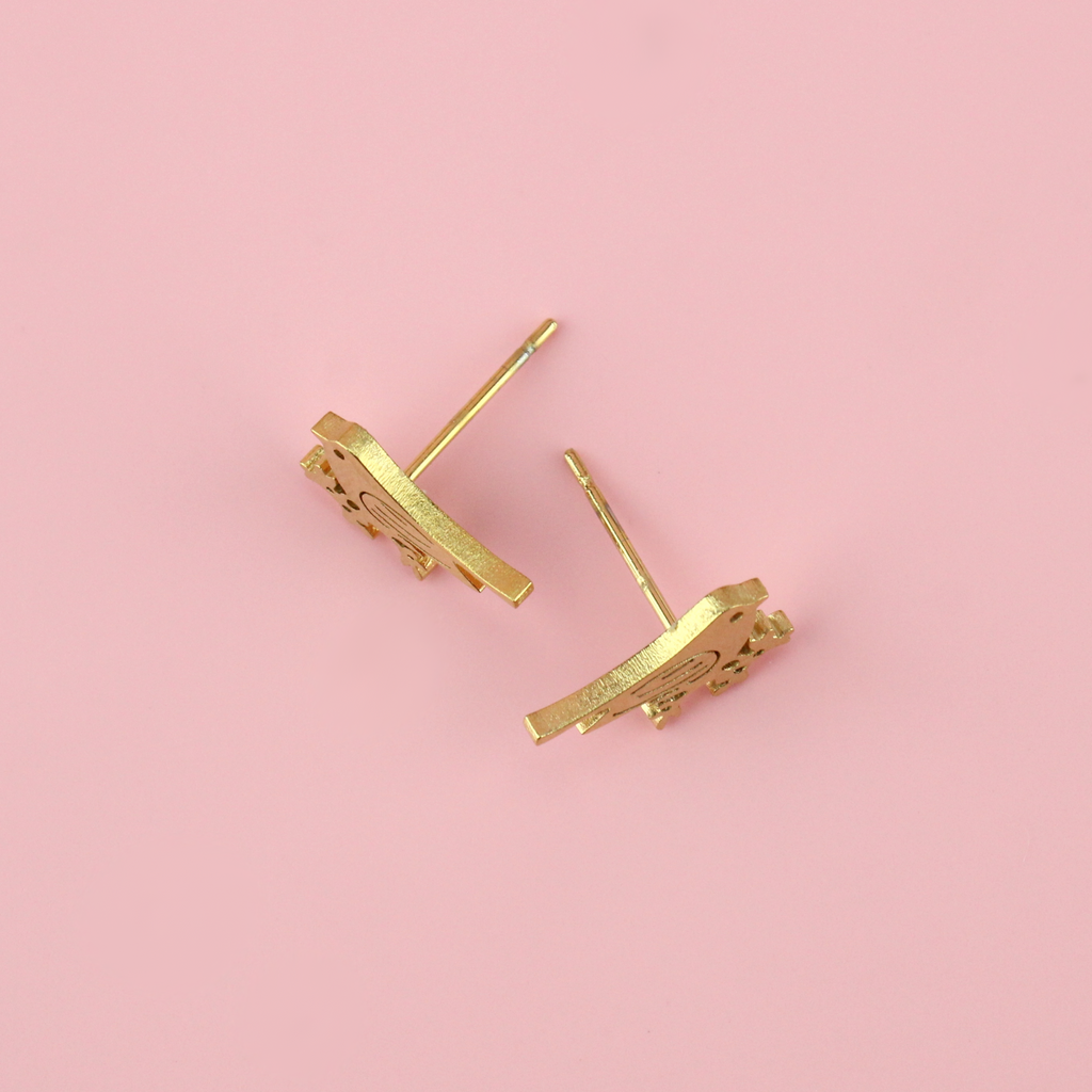 Gold plated stainless steel studs in the shape of a bird perched on a branch