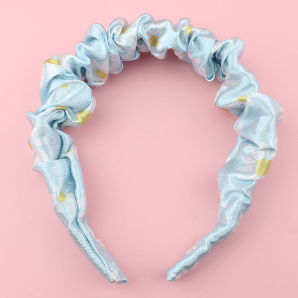 Pastel blue scrunchie style headband with a daisy design