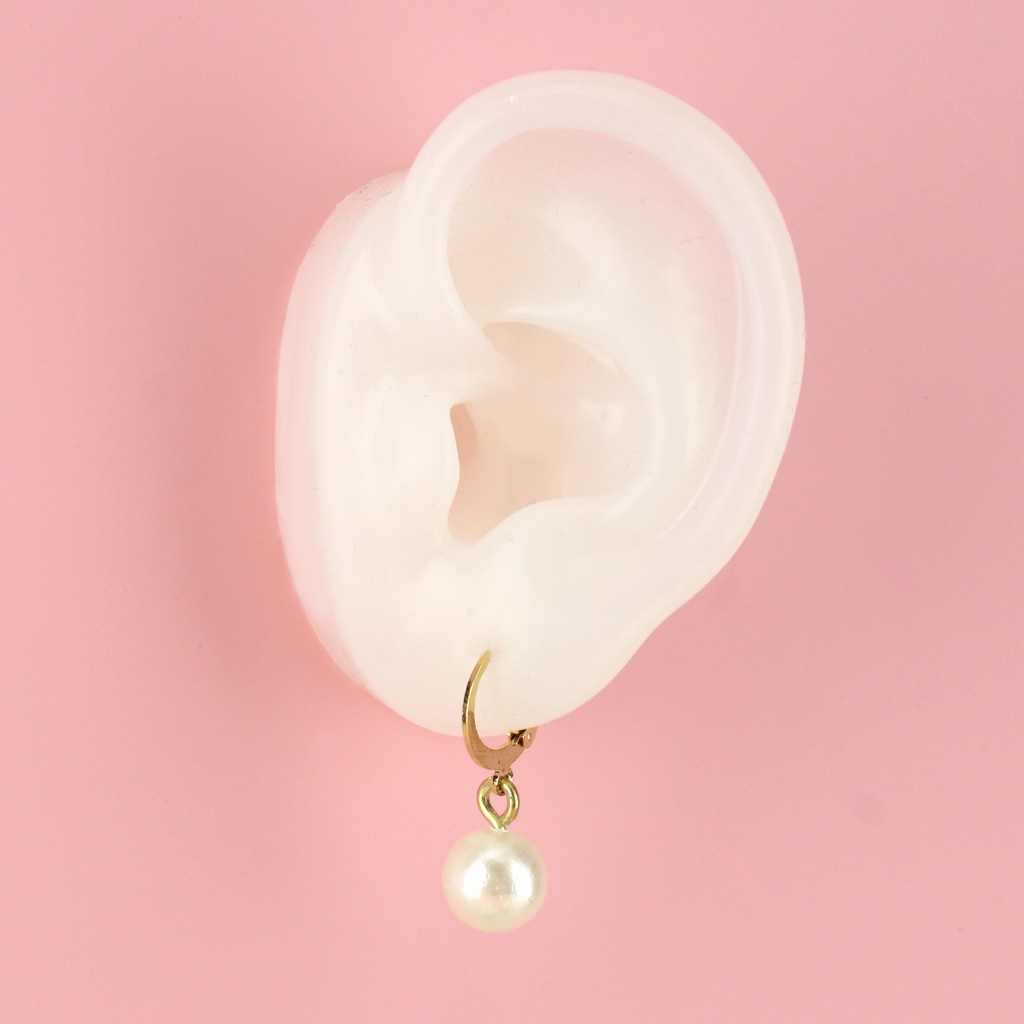Ear wearing Cherised Pearl Huggie Hoop Earrings (Gold Plated)