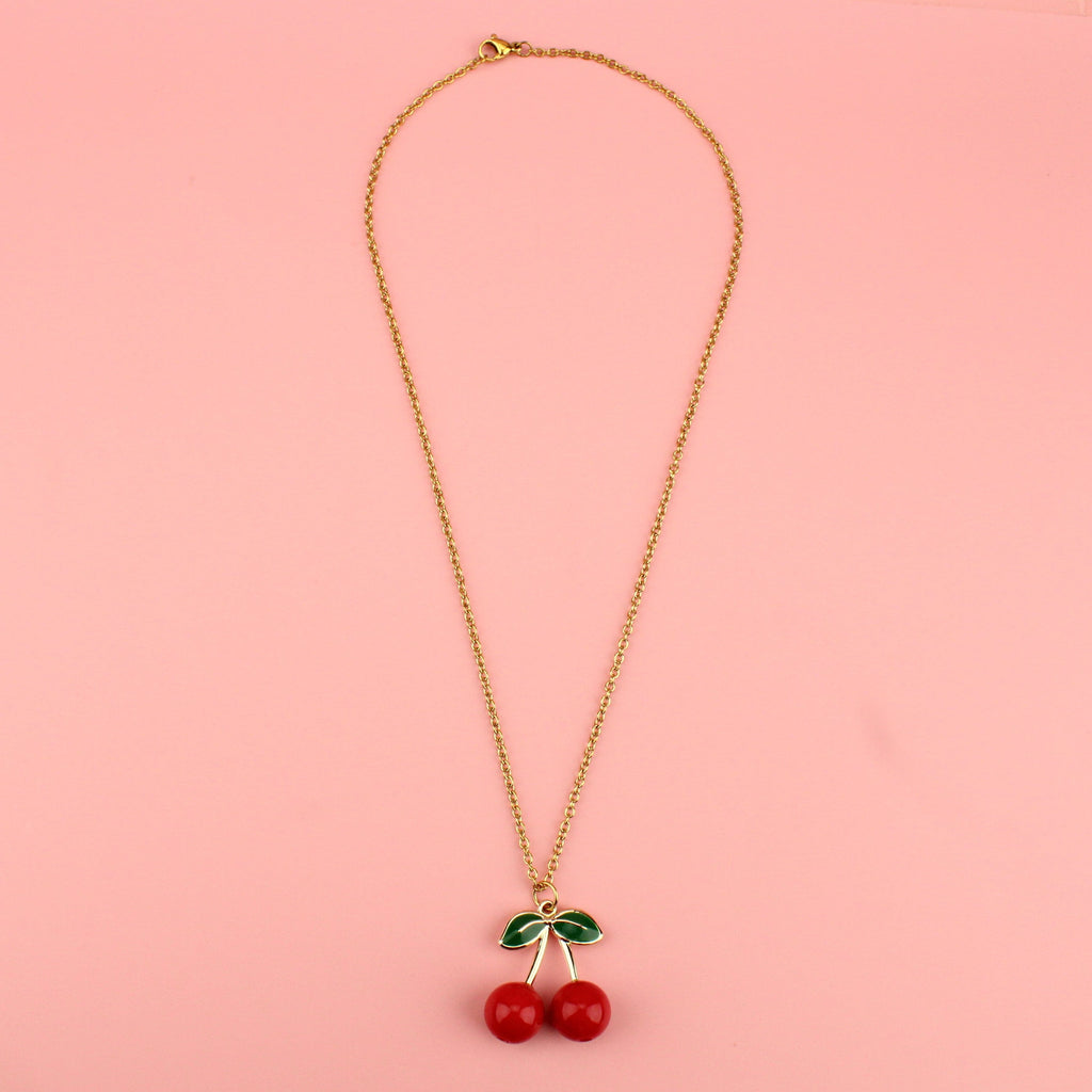 Red zinc alloy beads and gold plated stems and leaves on a gold plated stainless steel chain