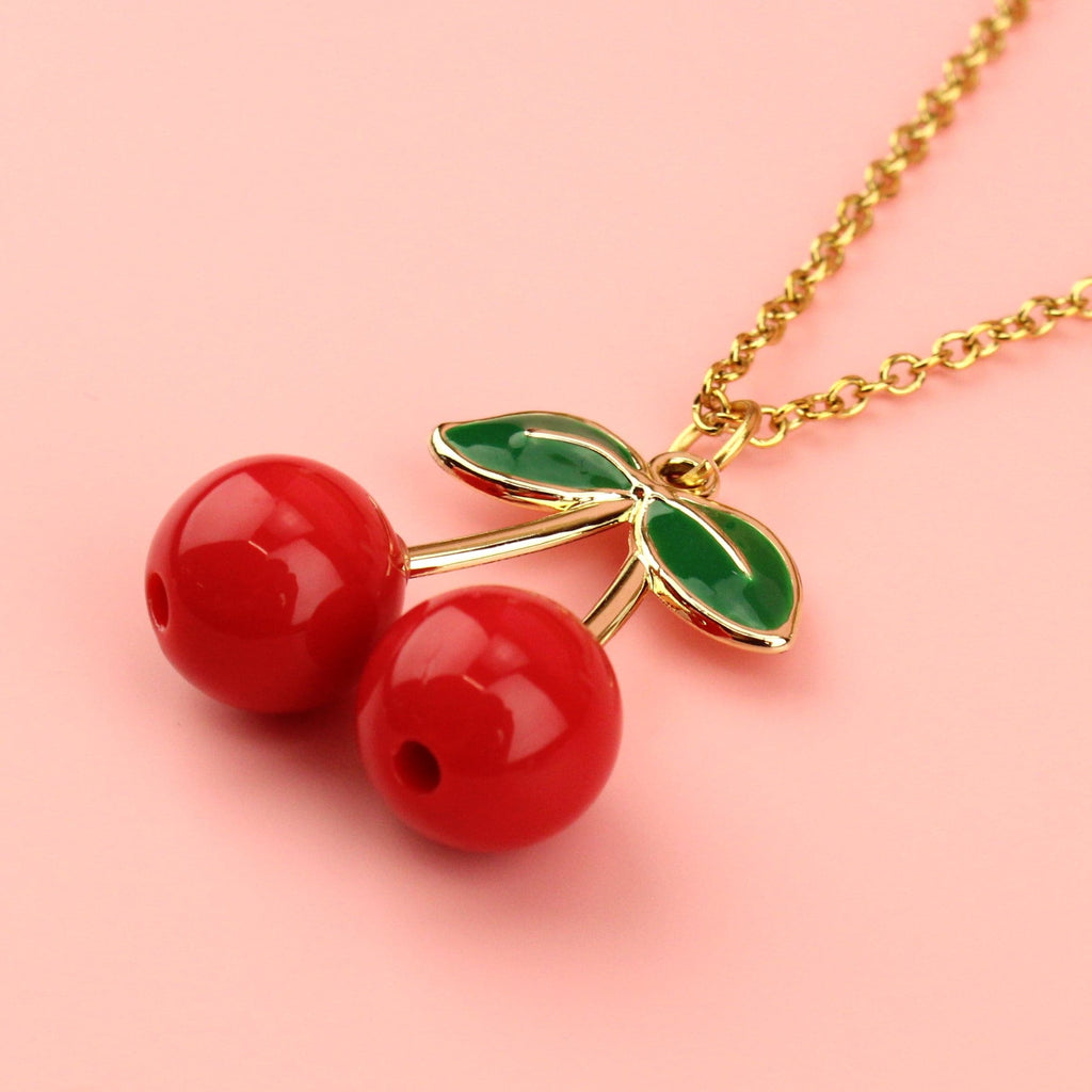 Red zinc alloy beads and gold plated stems and leaves on a gold plated stainless steel chain