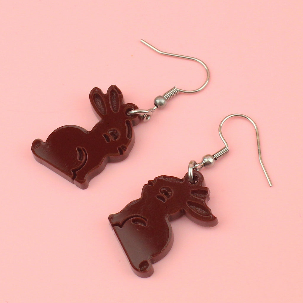 charms in the shape of chocolate bunnies with a bite taken out of one ear on stainless steel earwires