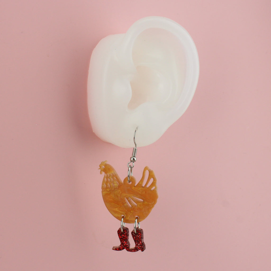 Ear wearing Cinnamon Chick Magnet Chicken Earrings
