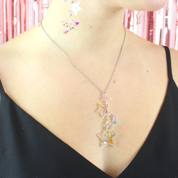 Model wearing confetti star charms on a stainless steel chain with matching earrings
