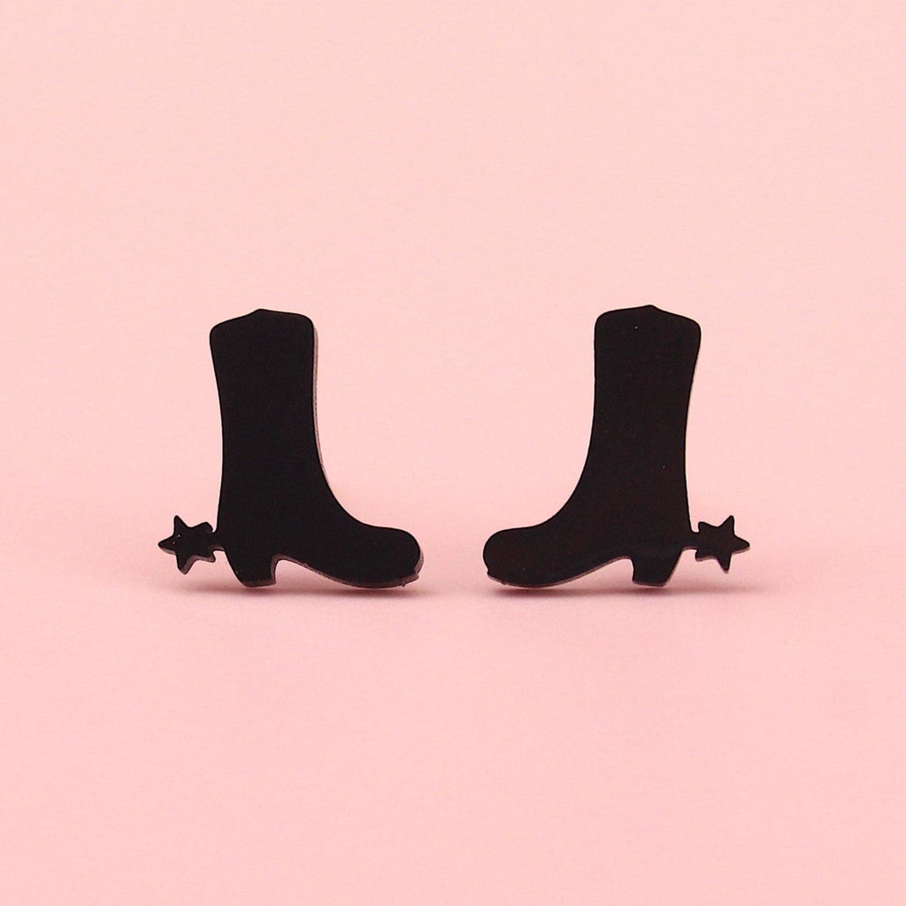Black cowboy boot shaped studs with aa star next to the heel made from stainless steel