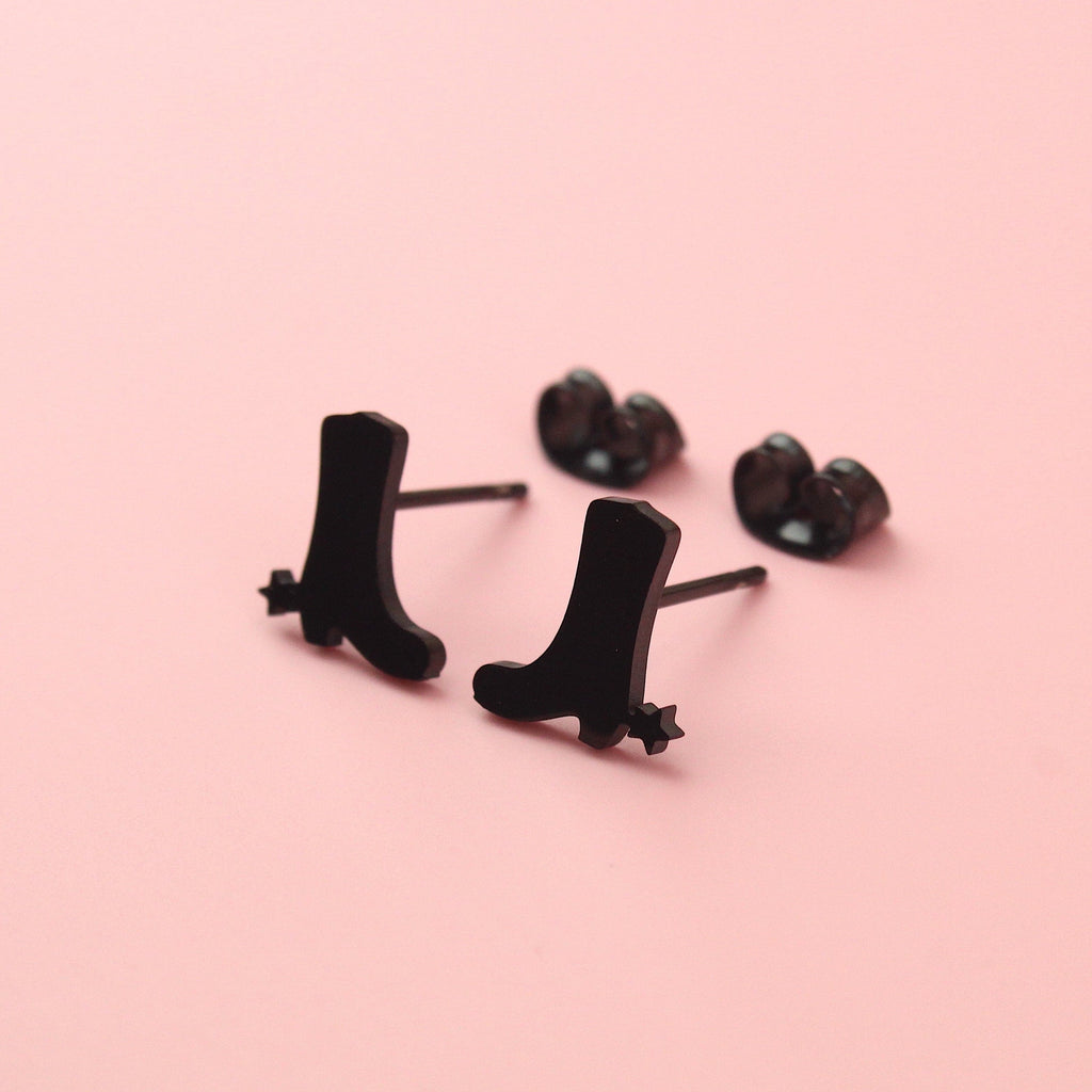 Black cowboy boot shaped studs with aa star next to the heel made from stainless steel