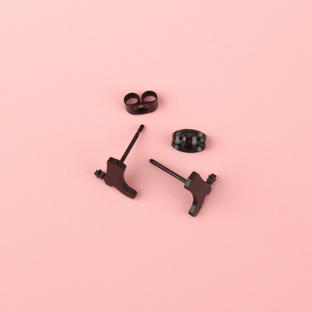 Black cowboy boot shaped studs with a star next to the heel made from stainless steel