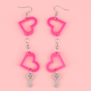 neon pink acrylic heart charms chained together to resemble handcuffs, with a key charm attached to the bottom