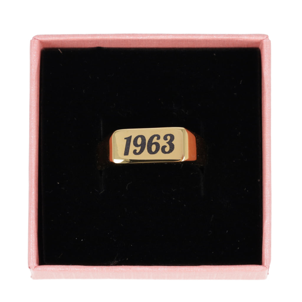 gold plated titanium with birth year engraved in black shown in a gift box