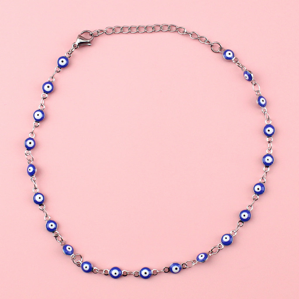 Dark blue evil eye charms on a stainless steel anklet