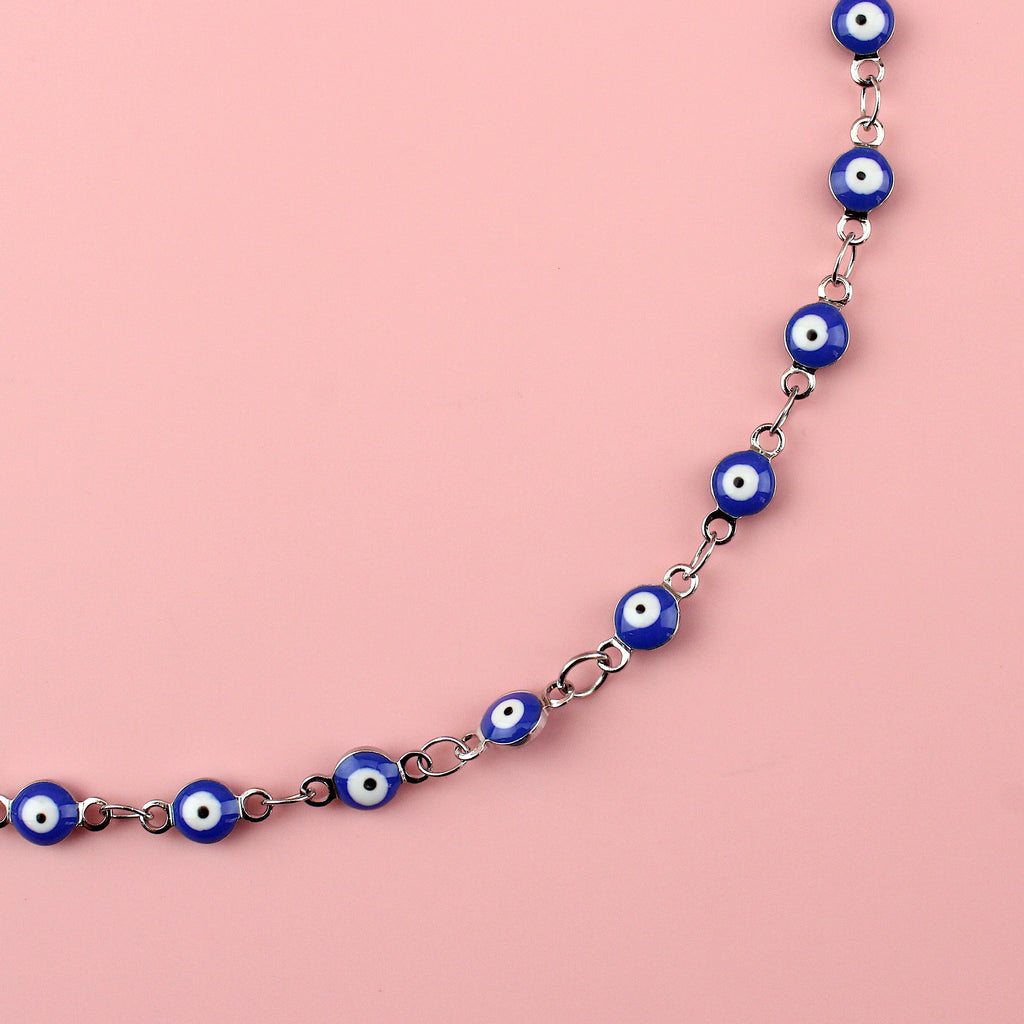 Dark blue evil eye charms on a stainless steel anklet