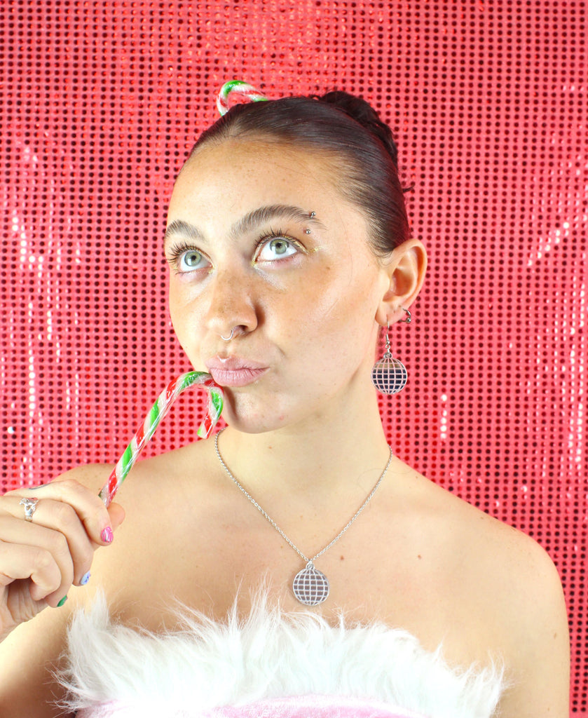 Model wearing disco ball earrings with matching necklace