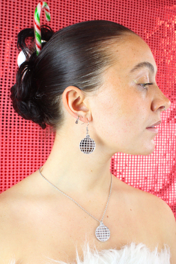 Model wearing disco ball earrings with matching necklace