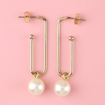 Gold plated earrings shaped similar to a paperclip wih pearl charms hanging from the bottom