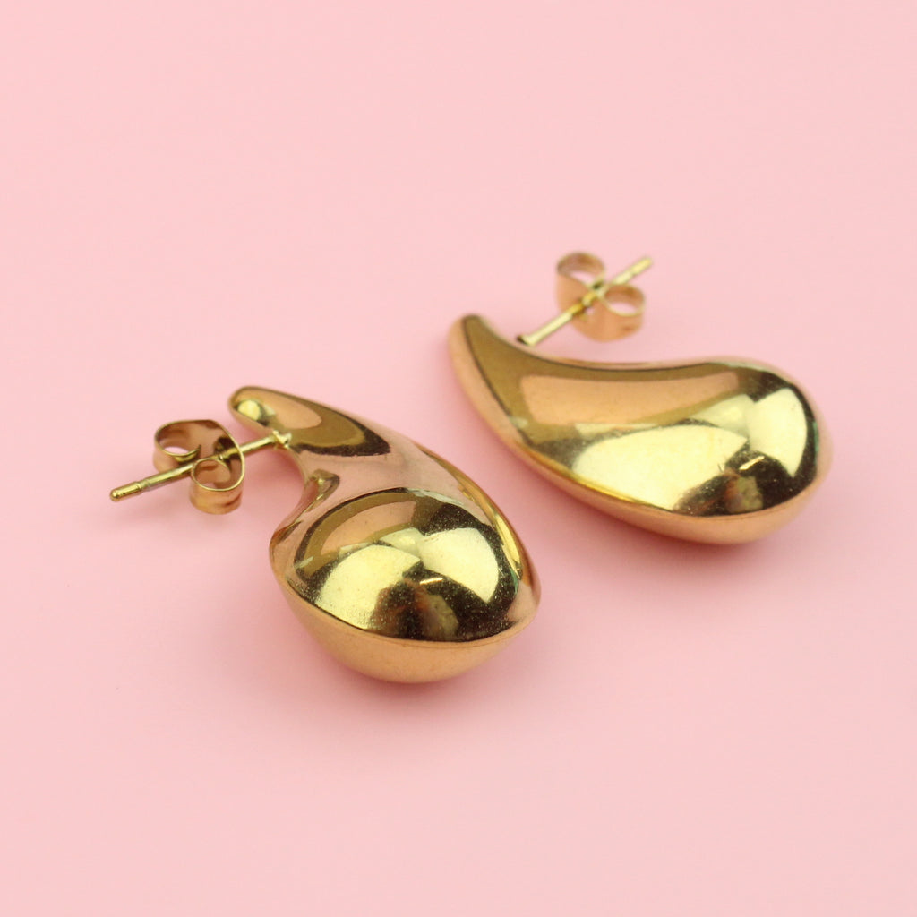 Gold plated stainless steel earrings in the shape of a droplet