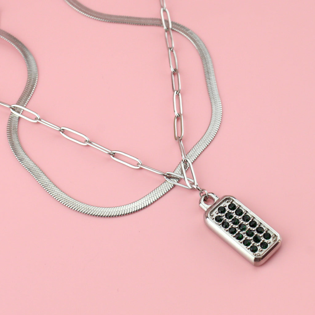 Close up of the pendant which features emerald cubic zirconia stones