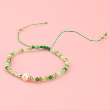 Green glass beads and brass beads on an adjustable nylon thread bracelet