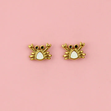 Crab shaped gold plated stainless steel studs with a white middle