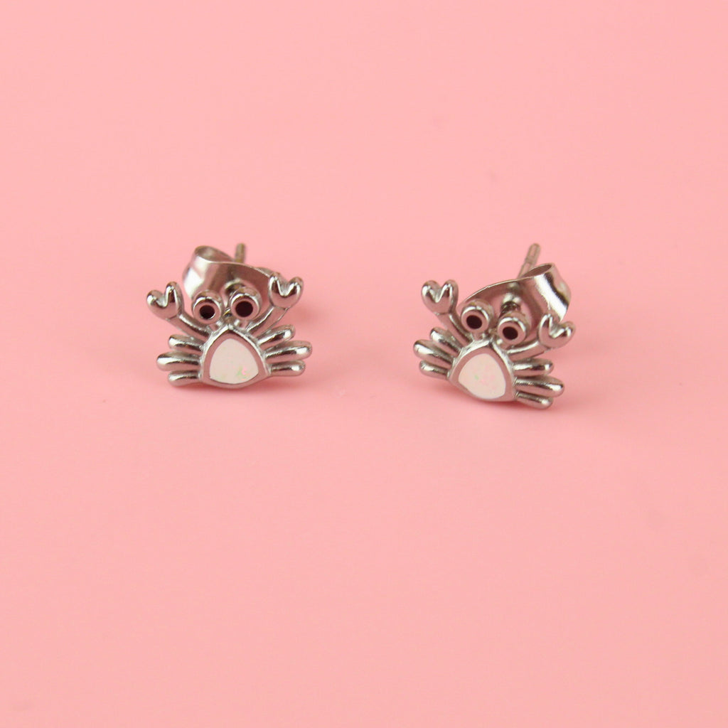 Crab shaped stainless steel studs with a white middle