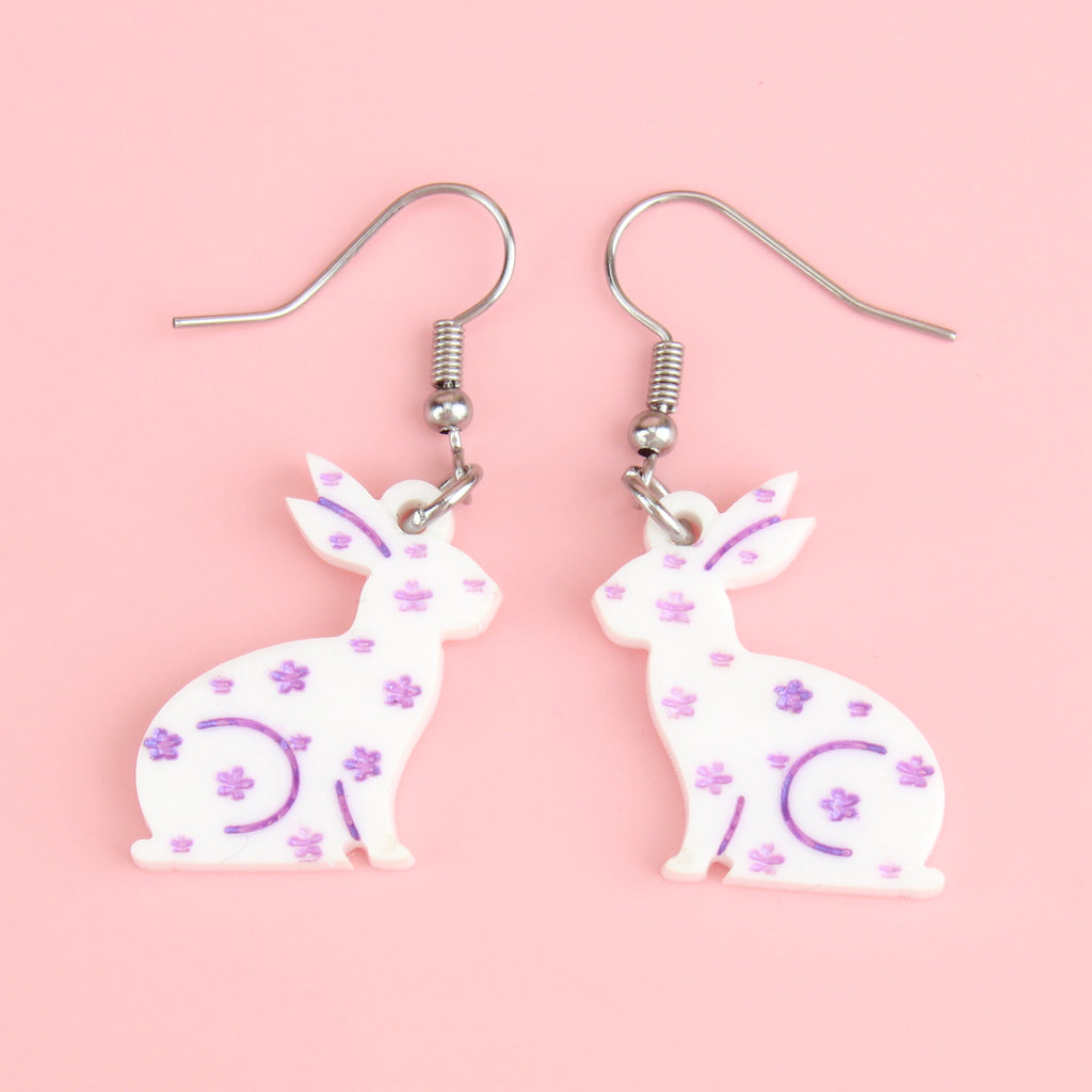 white acrylic bunnies with hand-painted purple flowers on stainless steel earwires