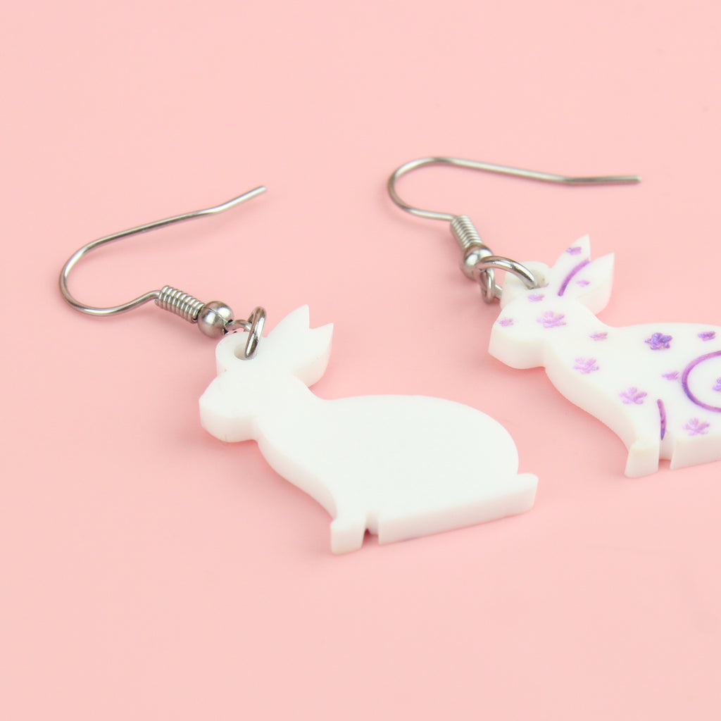 white acrylic bunnies with hand-painted purple flowers on stainless steel earwires