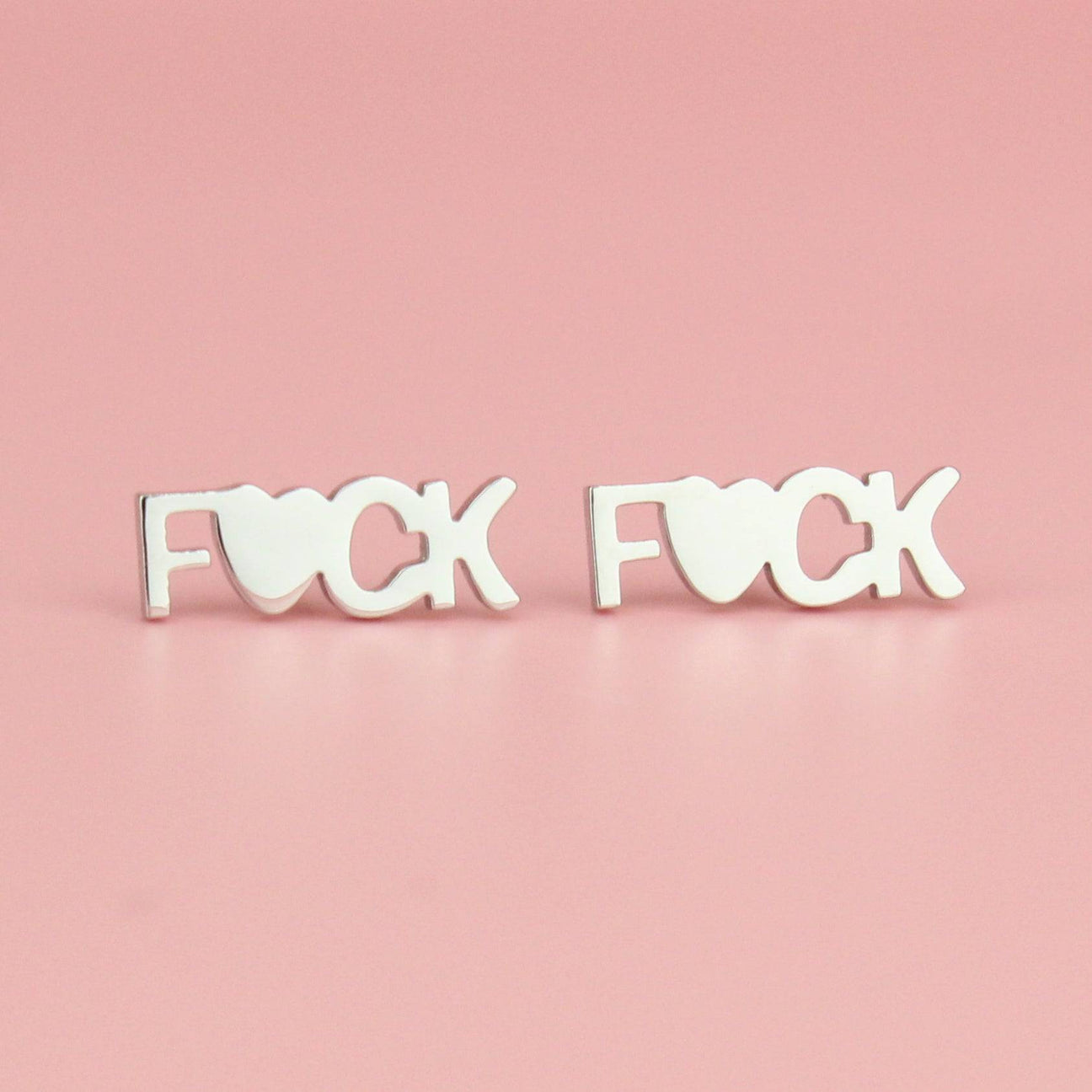 Studs with the word F*ck on with the U being replaced with a heart