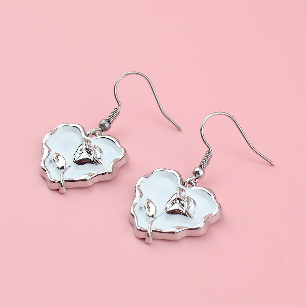 White heart charms with a silver outline and a silver rose in the middle on stainless steel earwires