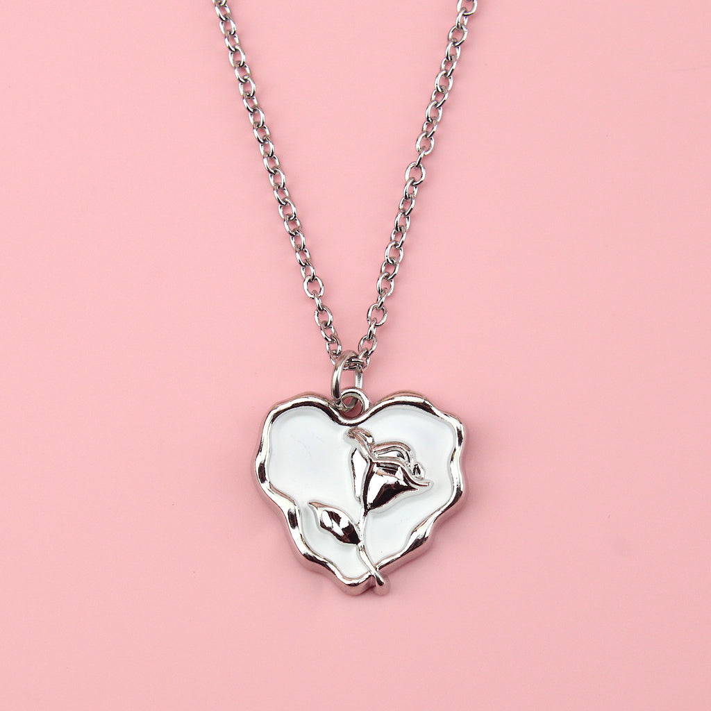 Stainless steel chain with a silver outlined white heart pendant featuring a silver rose inside
