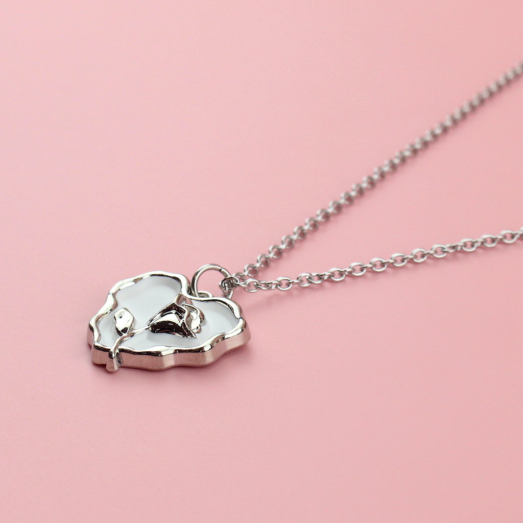 Stainless steel chain with a silver outlined white heart pendant featuring a silver rose inside