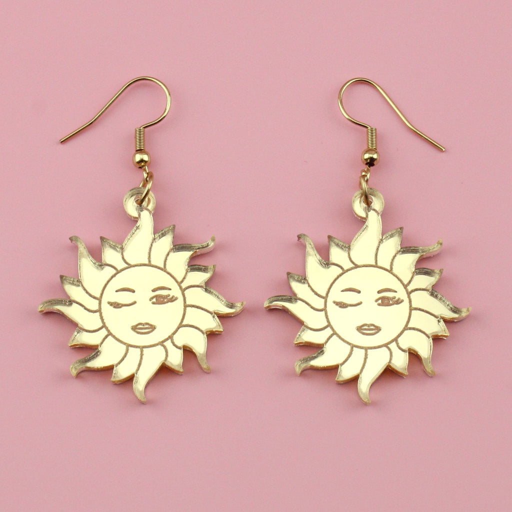 Gold mirrror acrylic charms with winking sun faces on gold plated stainless steel earwires