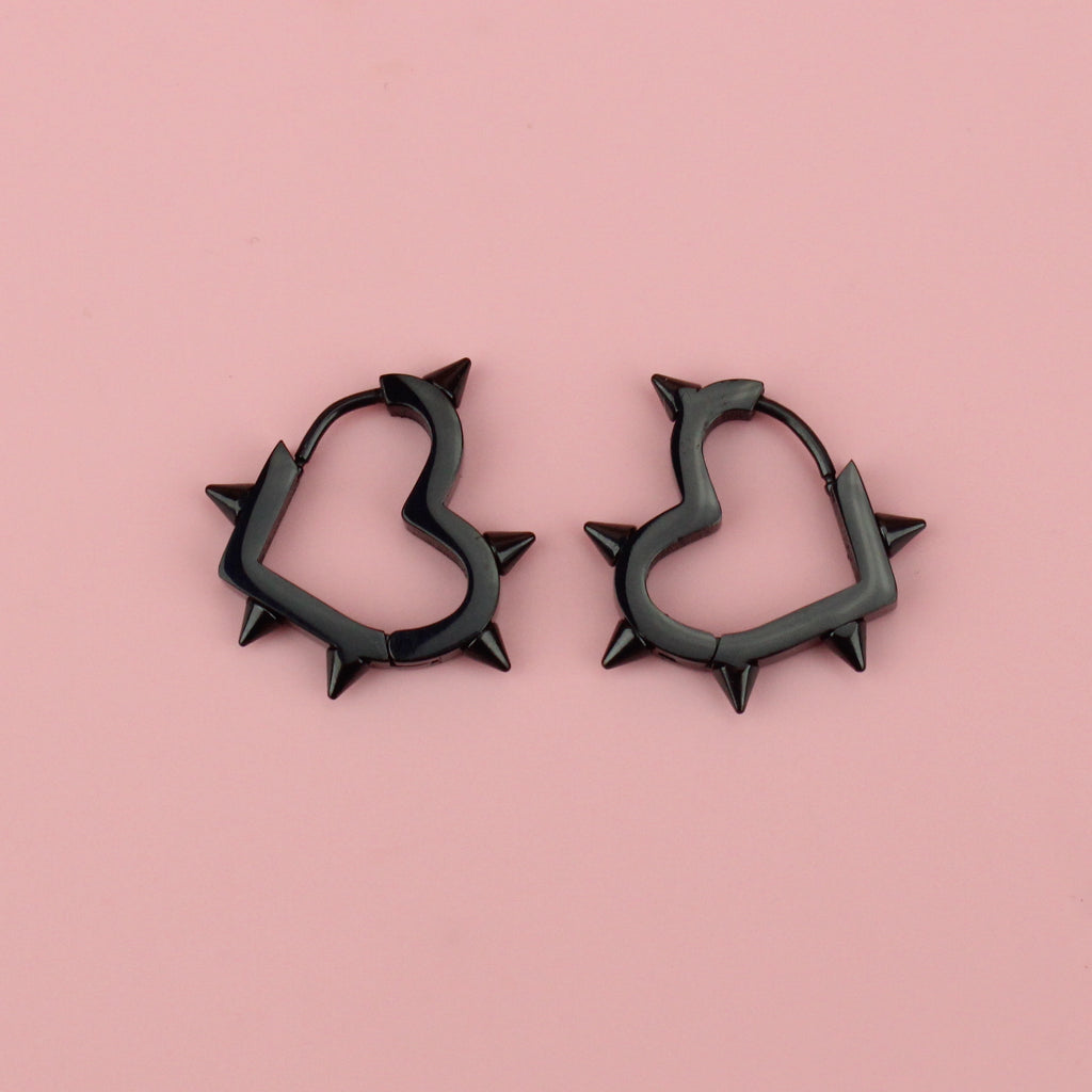 Black heart hoop earrings with punk-inspired spikes surrounding the edge