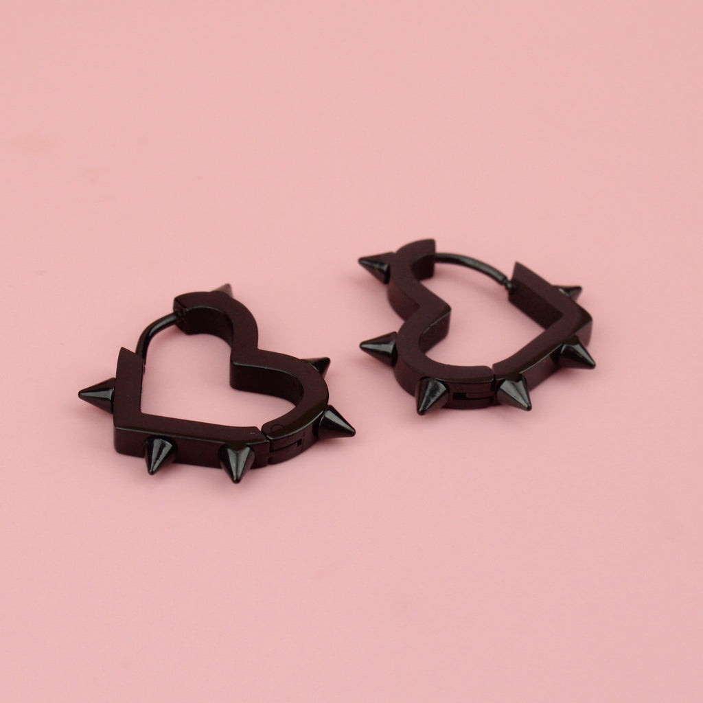 Black heart hoop earrings with punk-inspired spikes surrounding the edge