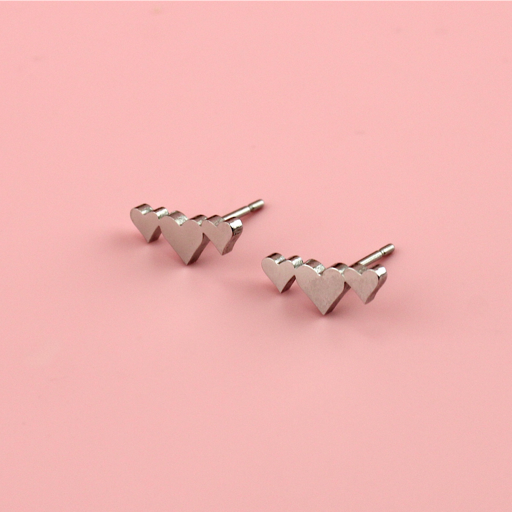 Stainless steel studs with a trio of silver hearts