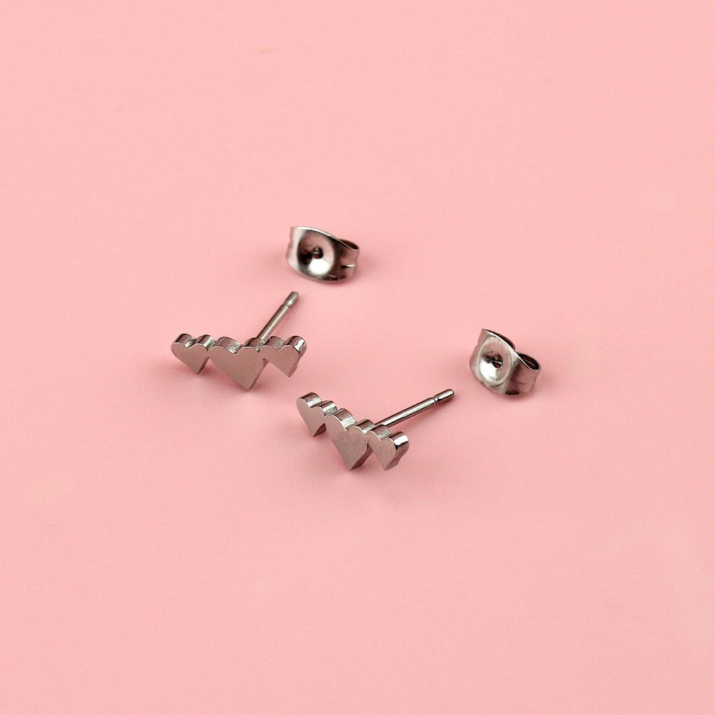 Stainless steel studs with a trio of silver hearts