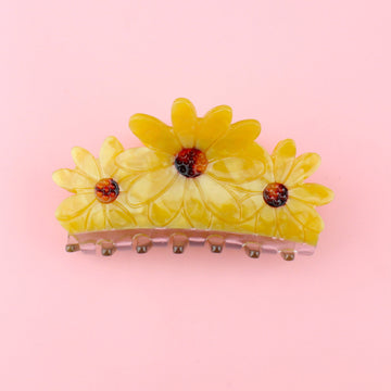 Claw clip made up of three acrylic sunflowers