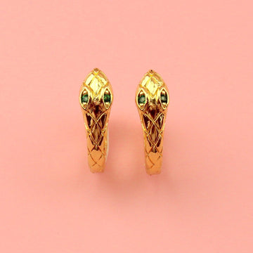 Gold plated snake hoop earrings featuring green cubic zirconia eyes